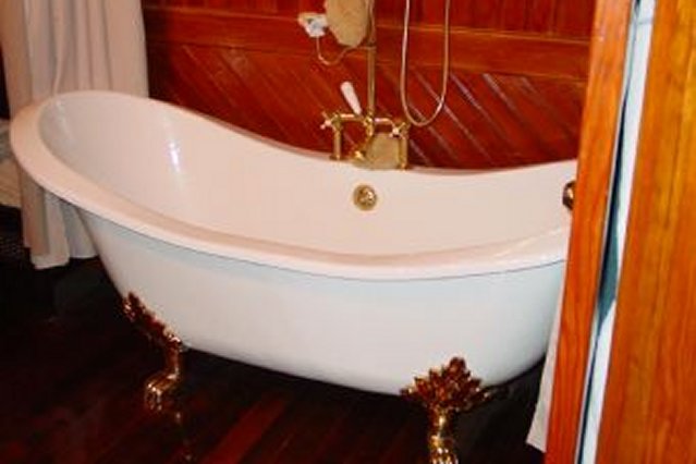 View of the downstairs bathroom with a built in clawfoot tub.